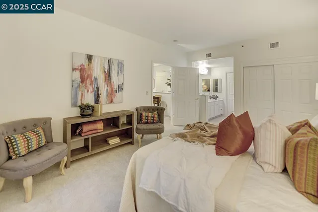 a bedroom with a bed and a couch