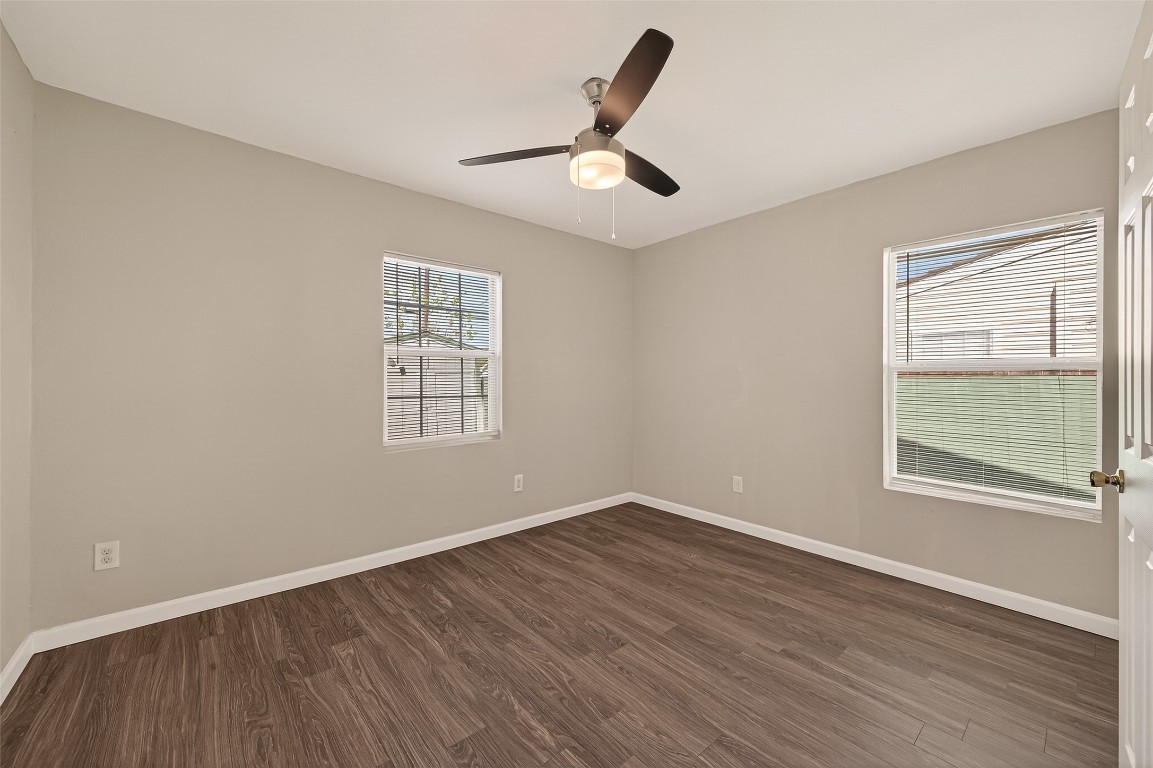 10141 Chadwick Street Houston, TX 77029 - Photo 13 of 25 a view of an empty room with wooden floor and a window