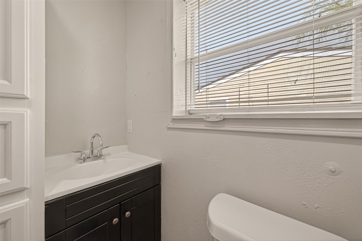 10141 Chadwick Street Houston, TX 77029 - Photo 19 of 25 a bathroom with a sink a toilet and a window