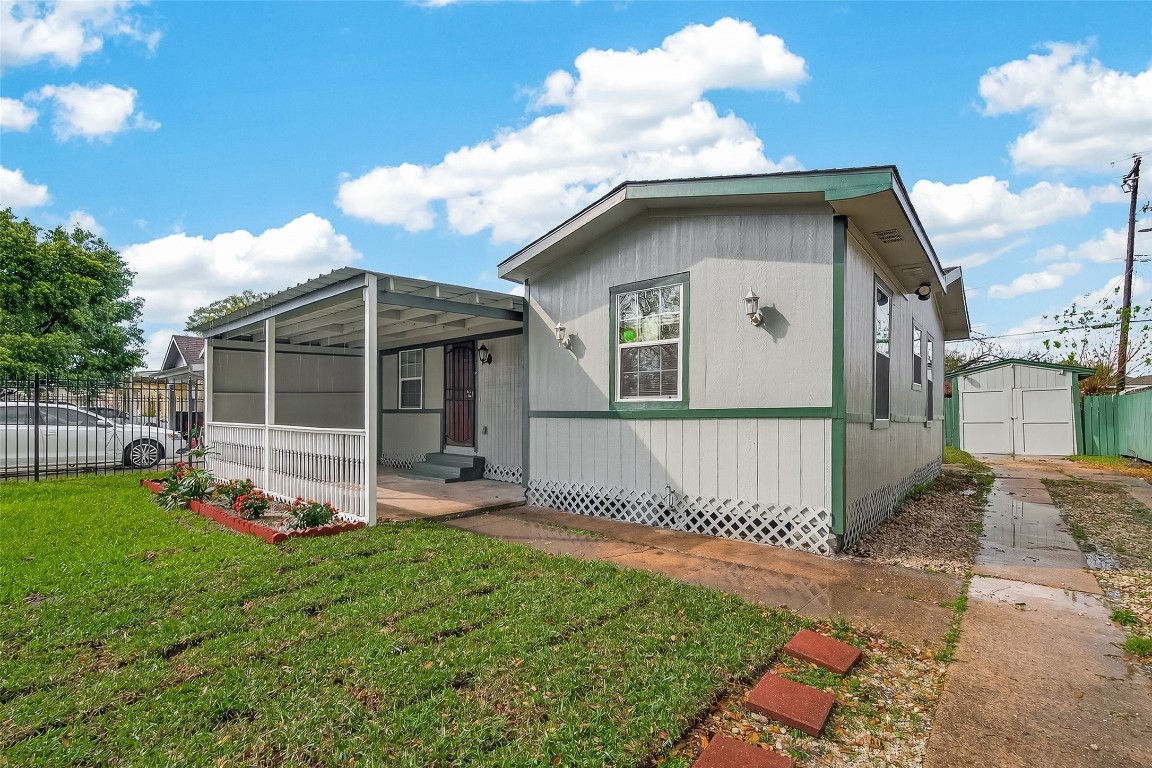 10141 Chadwick Street Houston, TX 77029 - Photo 21 of 25 a front view of a house with a yard and porch