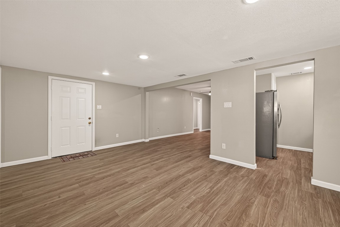 10141 Chadwick Street Houston, TX 77029 - Photo 7 of 25 a view of an empty room with wooden floor