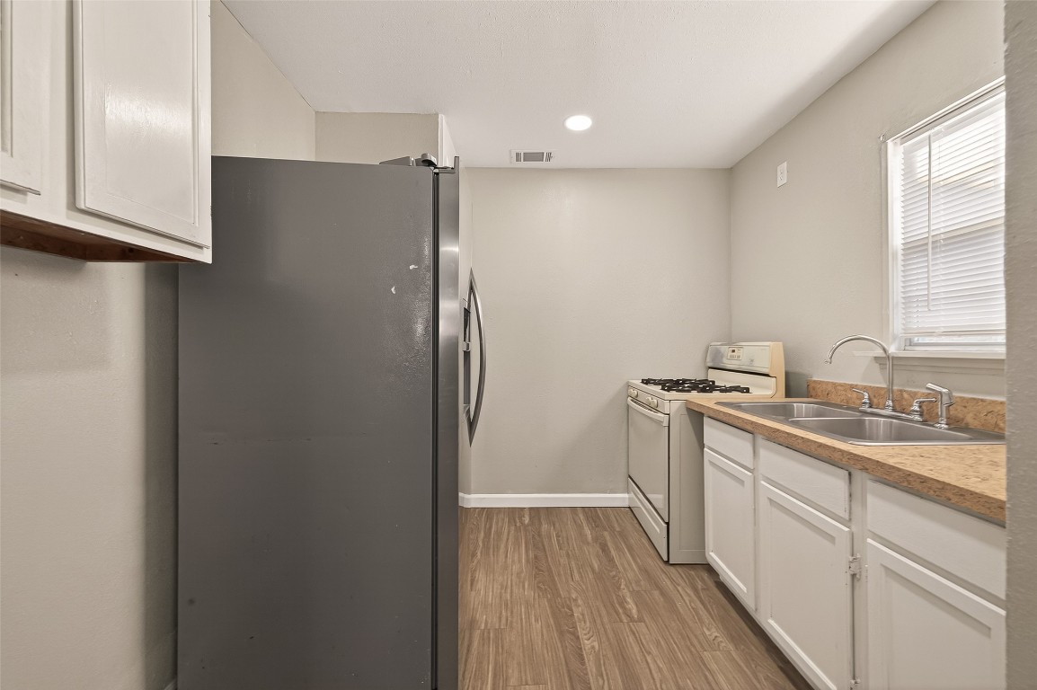 10141 Chadwick Street Houston, TX 77029 - Photo 8 of 25 a kitchen with a sink and refrigerator