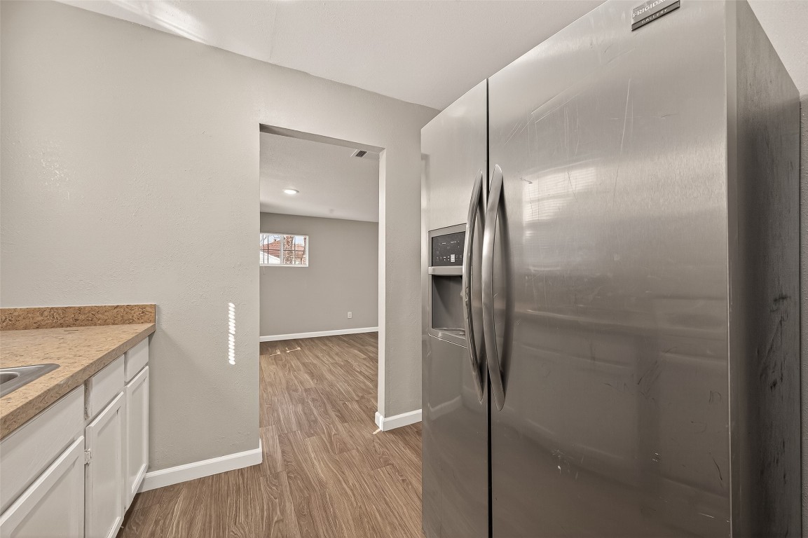 10141 Chadwick Street Houston, TX 77029 - Photo 10 of 25 a kitchen with a refrigerator and a sink