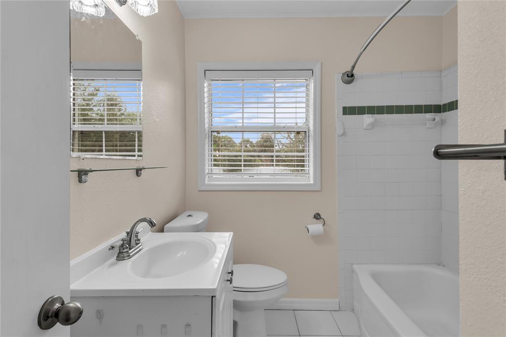 1124 Edgewater Court Orlando, FL 32804 - Photo 13 of 22 a bathroom with a sink toilet and shower