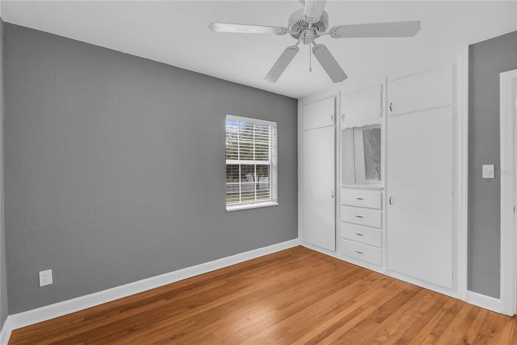 1124 Edgewater Court Orlando, FL 32804 - Photo 17 of 22 a view of empty room with wooden floor and fan
