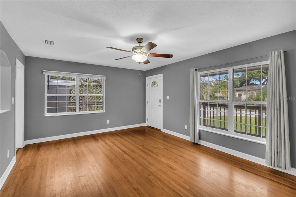 1124 Edgewater Court Orlando, FL 32804 - Photo 5 of 22 a view of an empty room with a window and wooden floor