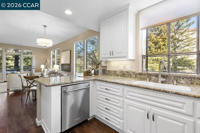 a living room with furniture a large window and a fireplace