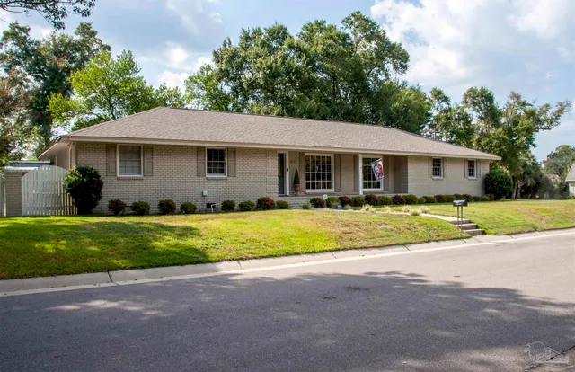 a front view of house with yard and green space