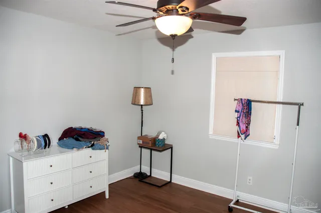 a view of a workspace with furniture and wooden floor