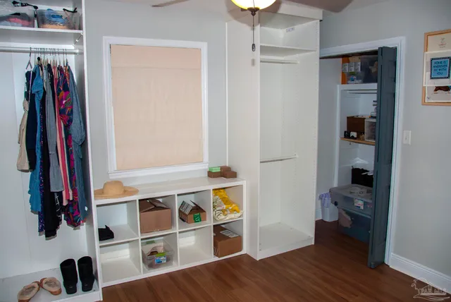 a view of walk in closet with clothes and shoes