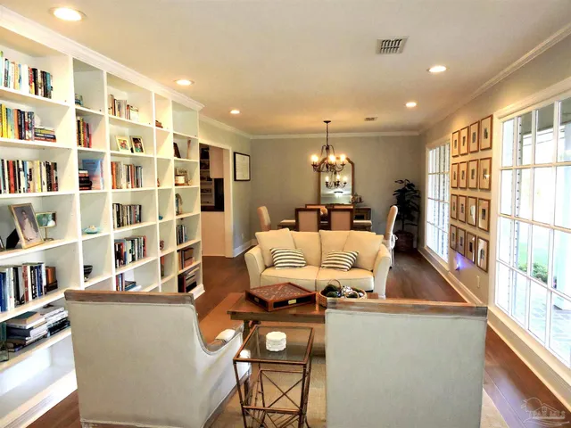 a living room with furniture and a book shelf