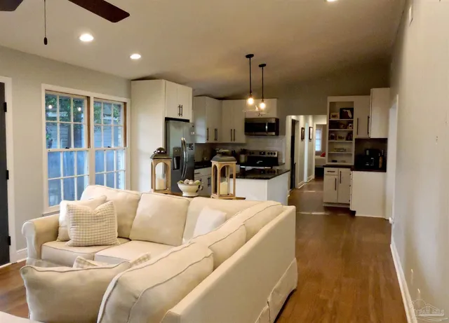 a living room with furniture and kitchen view