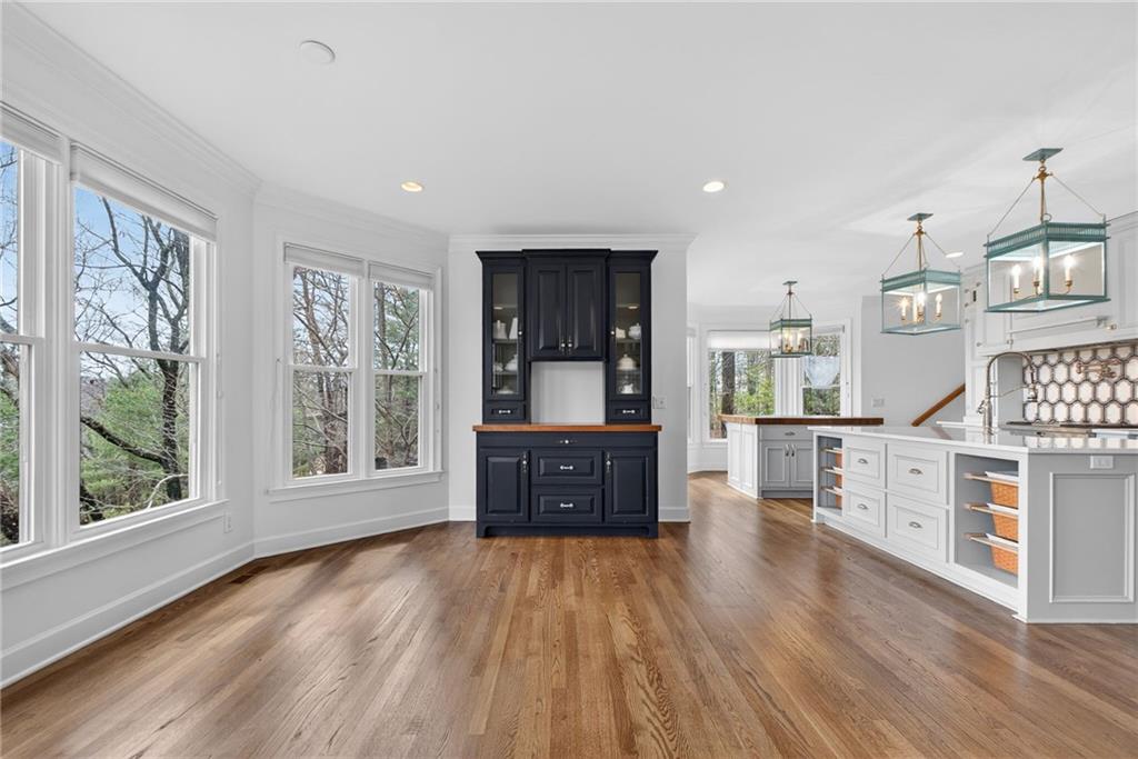 1027 Hunters Trace Jasper, GA 30143 - Photo 23 of 70 a large kitchen with stainless steel appliances granite countertop a stove a refrigerator a sink dishwasher and wooden cabinets with wooden floor