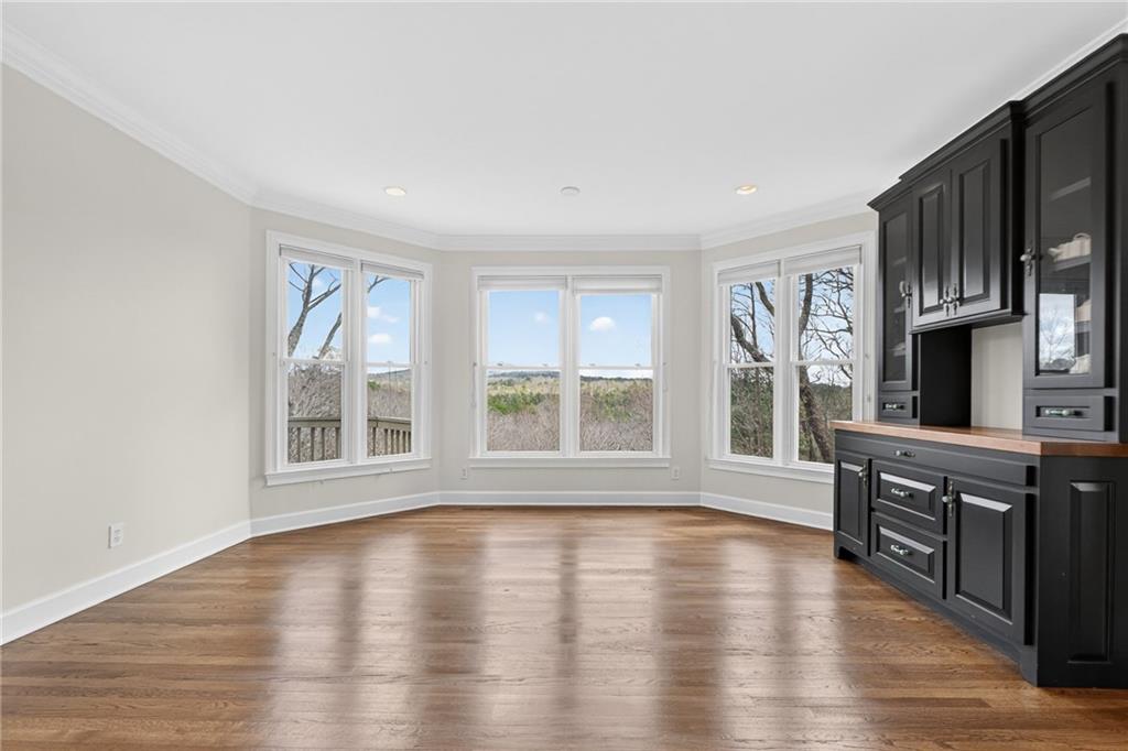 1027 Hunters Trace Jasper, GA 30143 - Photo 24 of 70 a view of an empty room with wooden floor and a window