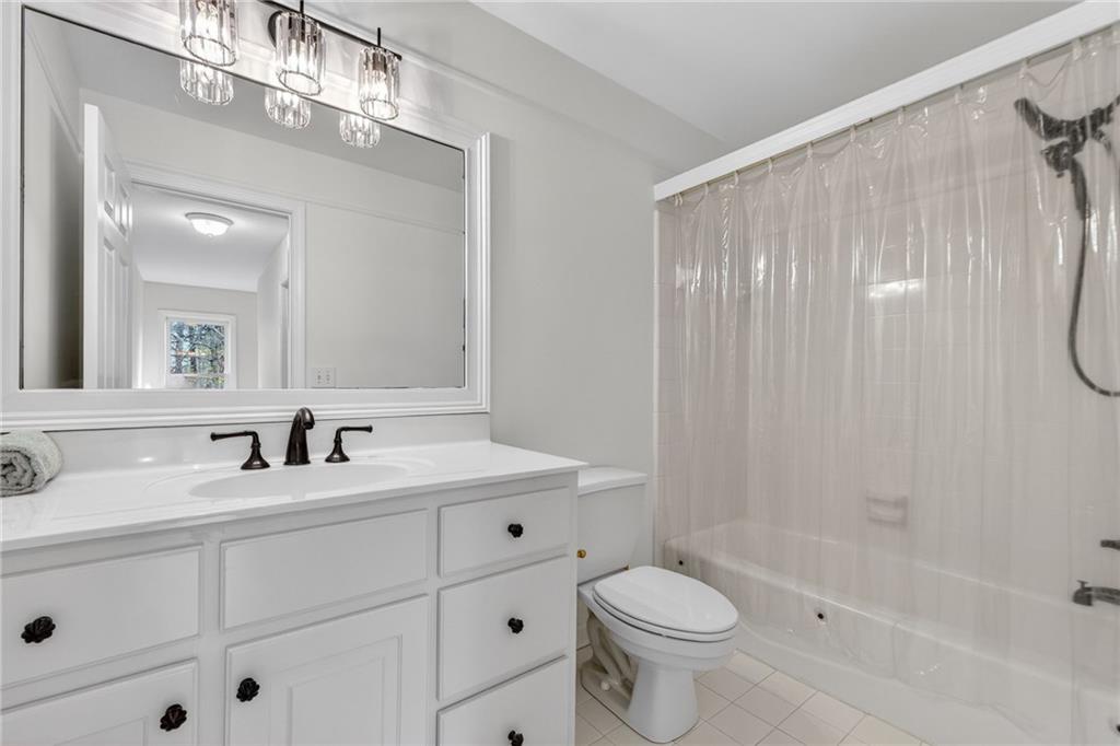 1027 Hunters Trace Jasper, GA 30143 - Photo 49 of 70 a bathroom with a double vanity sink mirror and toilet