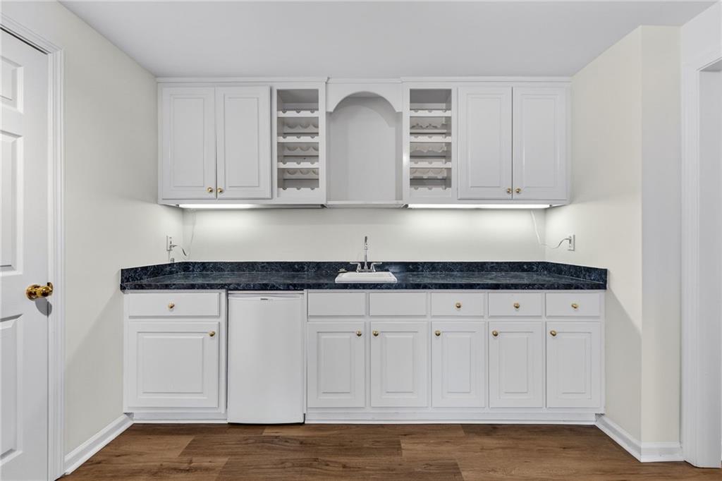 1027 Hunters Trace Jasper, GA 30143 - Photo 52 of 70 a kitchen with granite countertop white cabinets and a sink