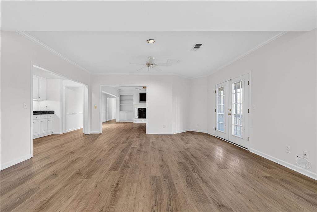 1027 Hunters Trace Jasper, GA 30143 - Photo 53 of 70 a view of empty room with wooden floor and kitchen