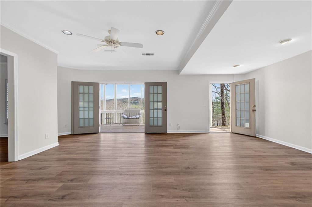 1027 Hunters Trace Jasper, GA 30143 - Photo 54 of 70 a view of an empty room with window and wooden floor