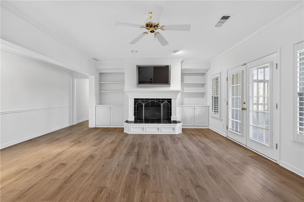 1027 Hunters Trace Jasper, GA 30143 - Photo 58 of 70 wooden floor fireplace and windows in a room