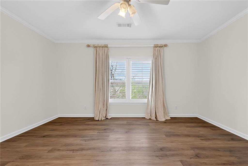 1027 Hunters Trace Jasper, GA 30143 - Photo 60 of 70 a view of empty room with wooden floor and fan
