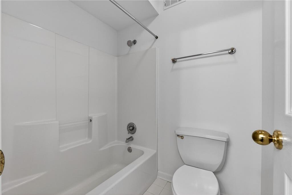 1027 Hunters Trace Jasper, GA 30143 - Photo 62 of 70 a bathroom with a toilet and a bathtub