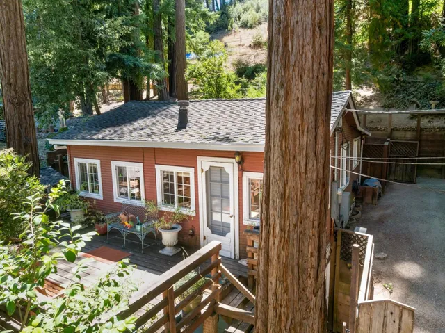 a view of house with a backyard and sitting area
