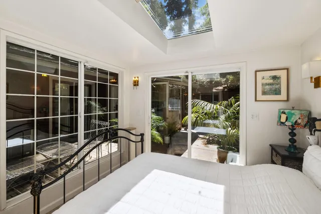 a bedroom with furniture and a large window