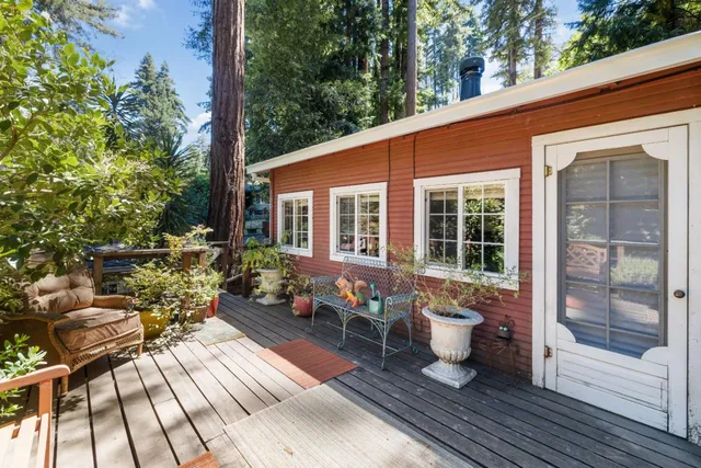 a balcony with wooden floor table and chairs