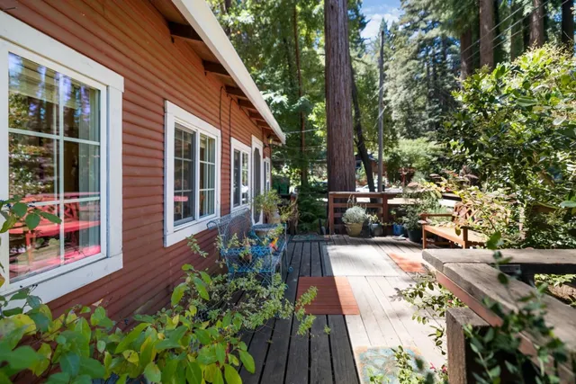 a view of a house with potted plants