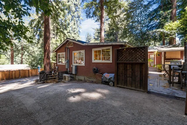 a view of a house with a yard and sitting area