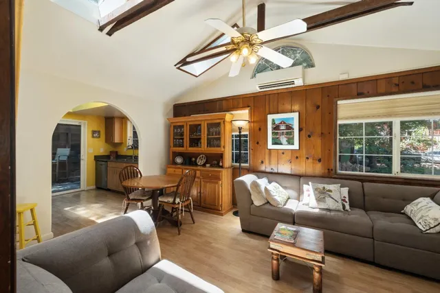 a living room with furniture and large windows