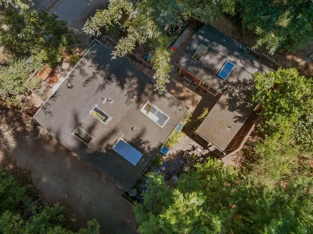 an aerial view of a house with a yard