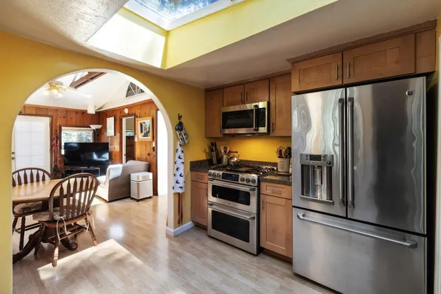 a kitchen with stainless steel appliances a refrigerator stove microwave and sink