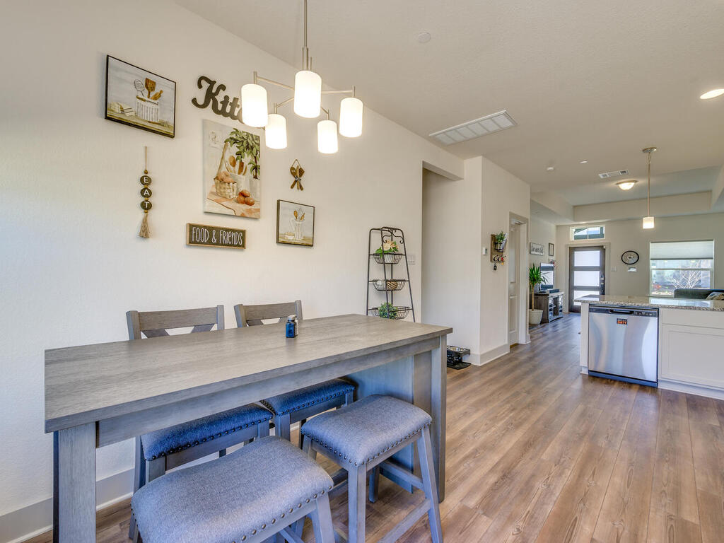 2257 Local Rebel Loop Leander, TX 78641 - Photo 14 of 26 a view of a dining room with furniture and wooden floor