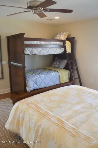 a view of a hallway with wooden floor and stairs