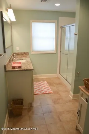 a view of a hallway with wooden floor and furniture