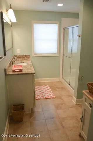 a view of a hallway with wooden floor and furniture