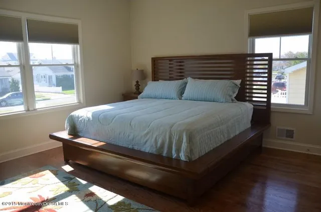 a bathroom with a granite countertop toilet sink and mirror