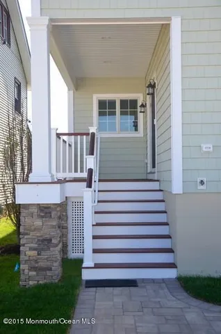 a view of a house with a small yard and stairs
