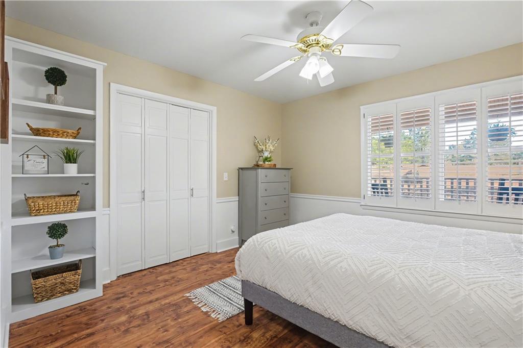 1833 Tom Odum Road Vidalia, GA 30474 - Photo 30 of 59 a bedroom with a large bed a chandelier and a window