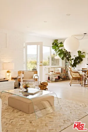 a living room with furniture and a floor to ceiling window