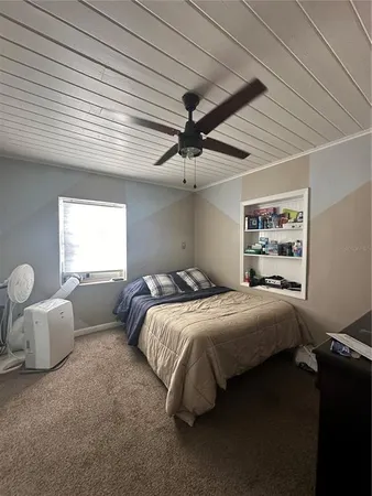 a bedroom with bed and window