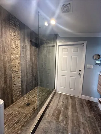 a bathroom with a shower and closet