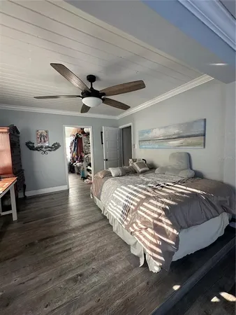 a bed room with a bed and a ceiling fan