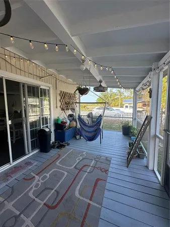 a living room with furniture a window and wooden floor