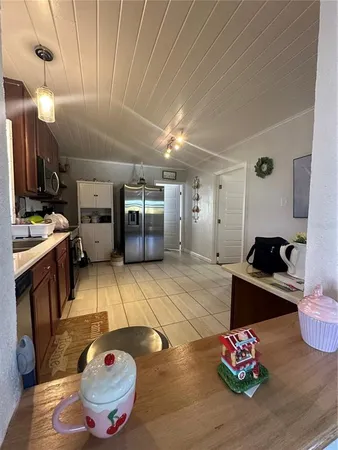 a kitchen with furniture and a flat screen tv