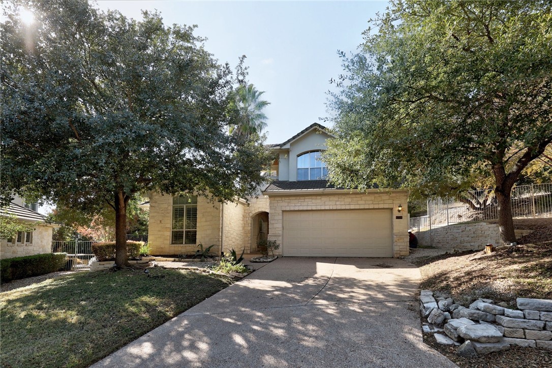 a front view of a house with a yard and garage
