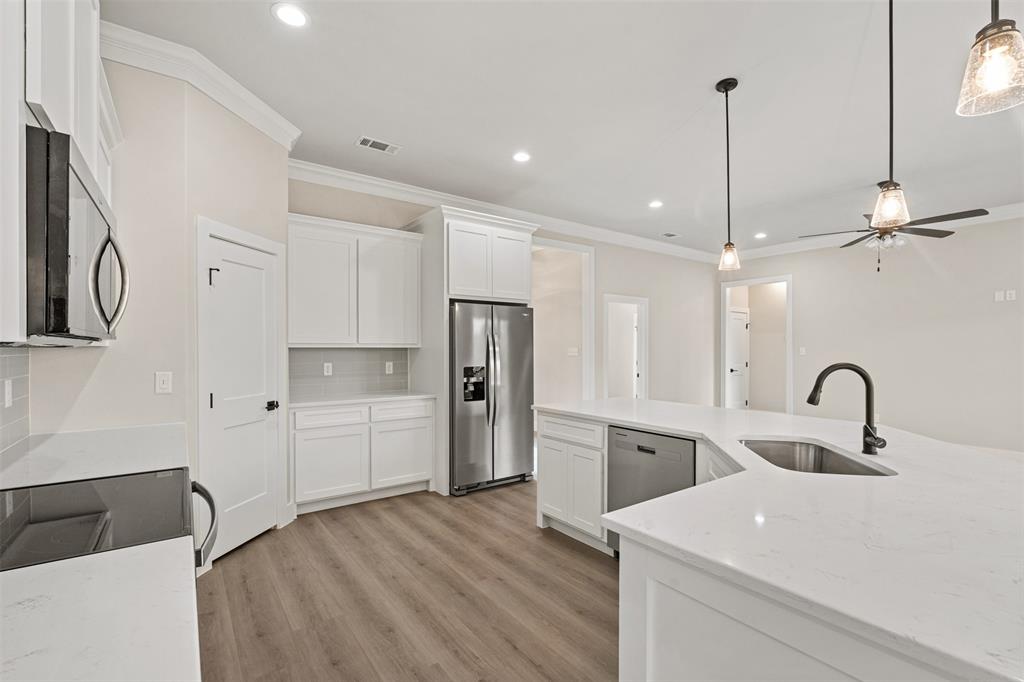 506 Limestone Circle Mabank, TX 75147 - Photo 8 of 33 a kitchen with a refrigerator sink and cabinets