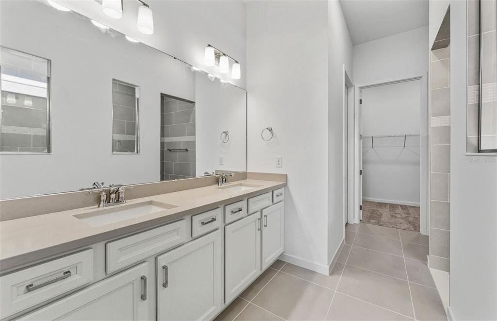 13655 Cyn Rdg Road Spring Hill, FL 34610 - Photo 9 of 28 a spacious bathroom with a double vanity sink mirror and double