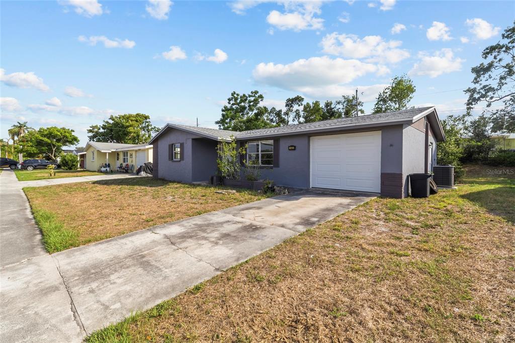 1623 Plum Tree Road Holiday, FL 34690 - Photo 2 of 33 a view of a house with a yard